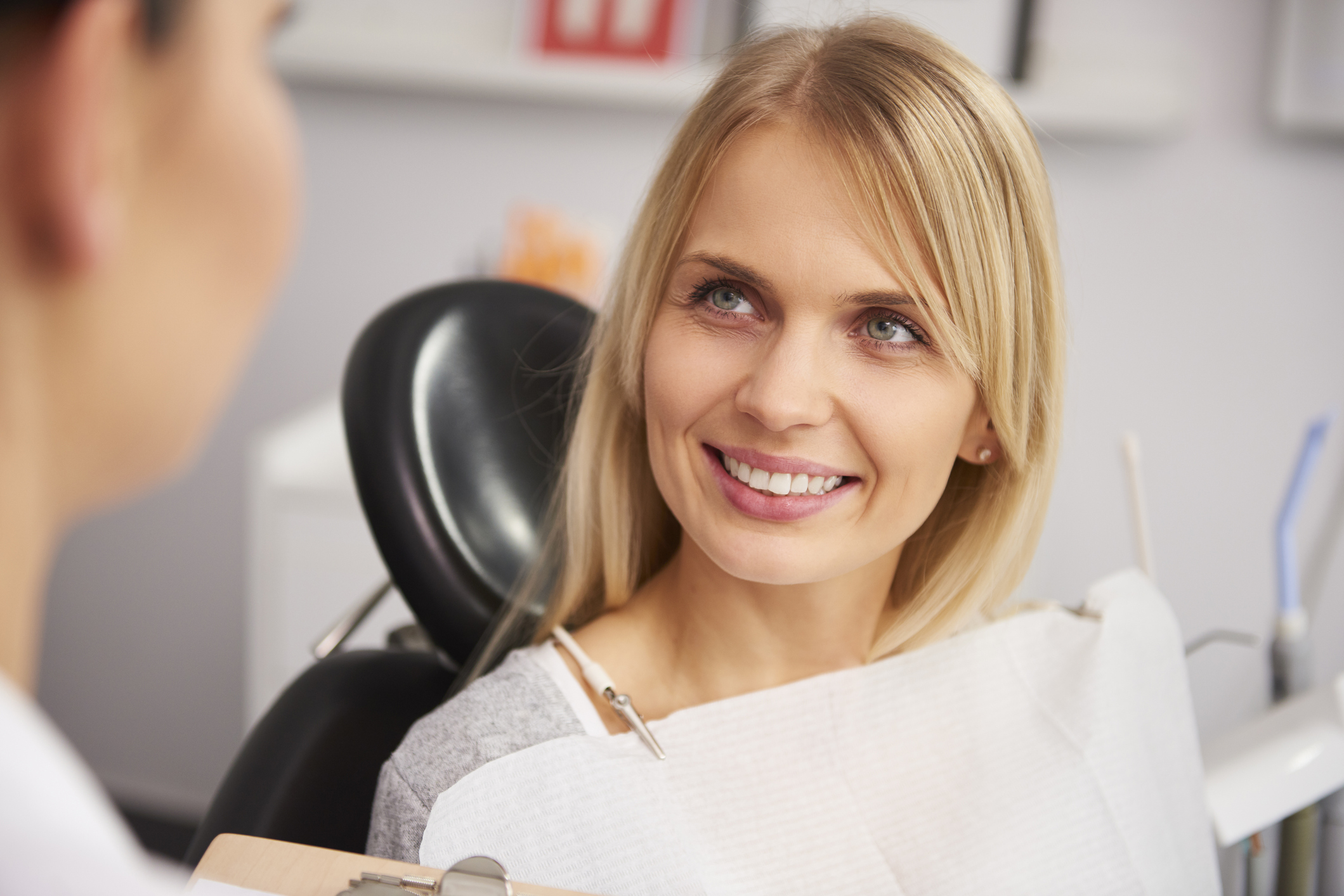 Pleased and smiling woman in dentist’s clinic